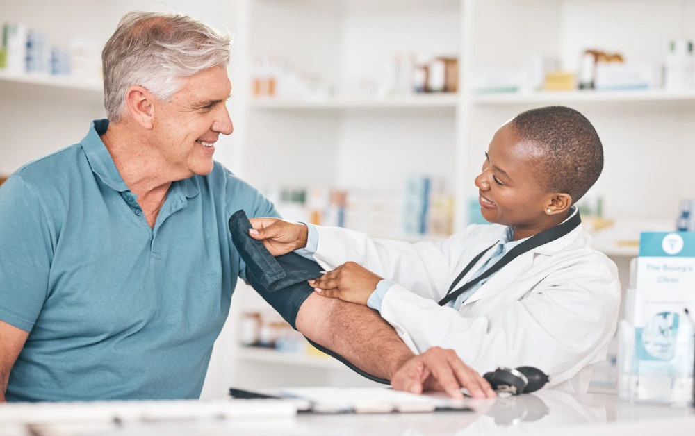 An older male getting his blood pressure checked by his PharmaChoice pharmacist.