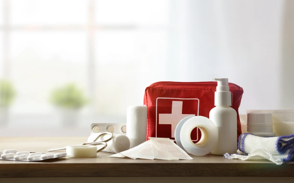 first aid kit items like scissors, bandages, and tape