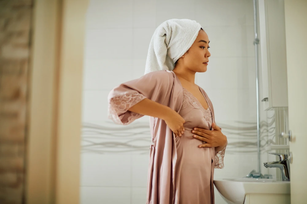 woman doing a self-screen for breast cancer
