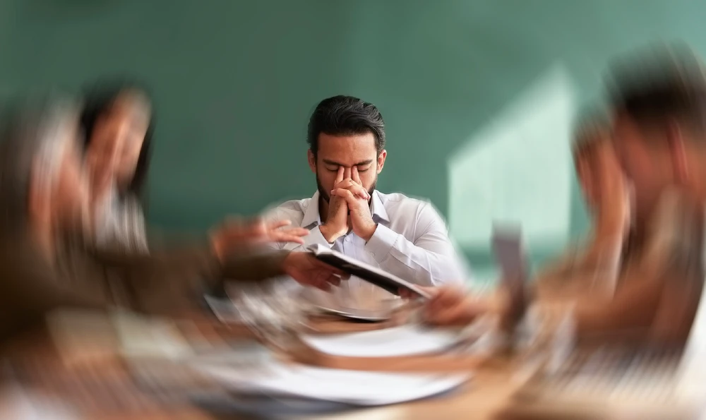 man having a migraine aura, a type or migraine symptom