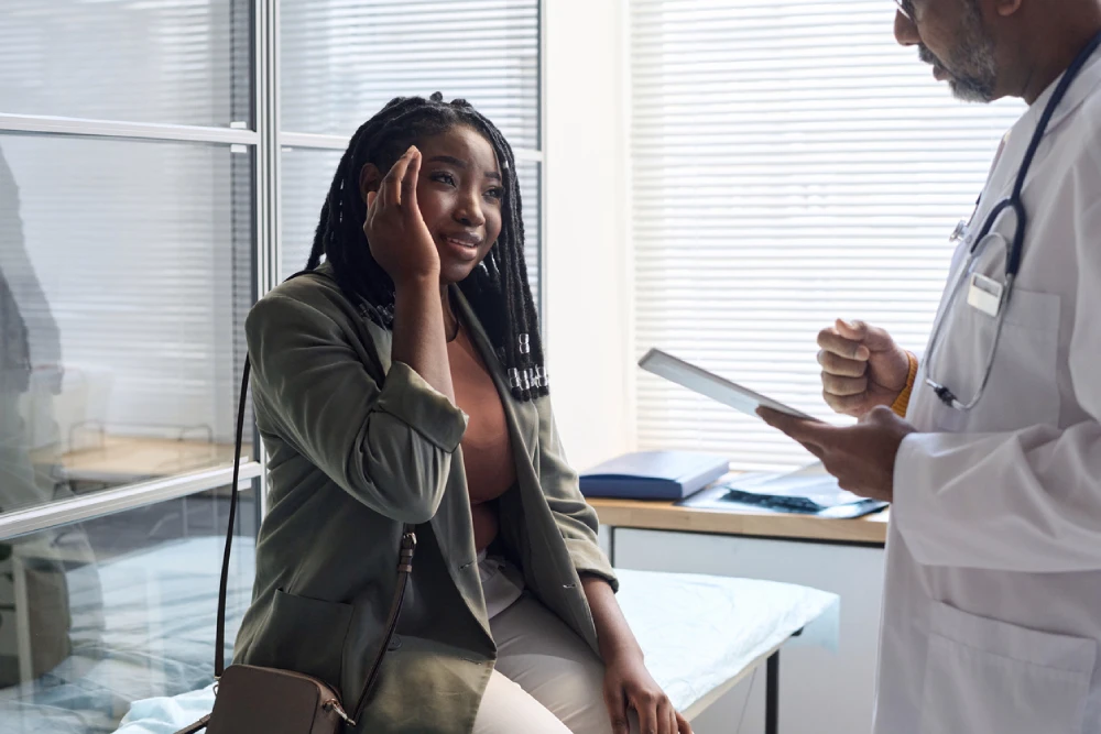 female patient talking to her doctor about migraines