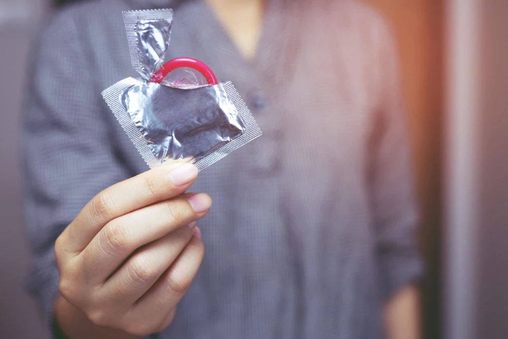 woman holding a condom