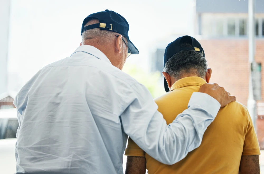 an older man supporting his friend with PTSD