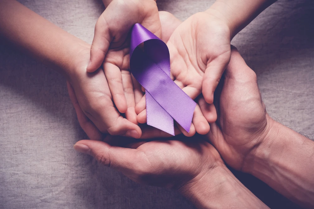 a purple overdose awareness ribbon in a group of palms