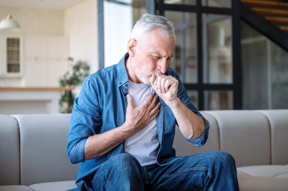 man coughing, a common sign of lung cancer