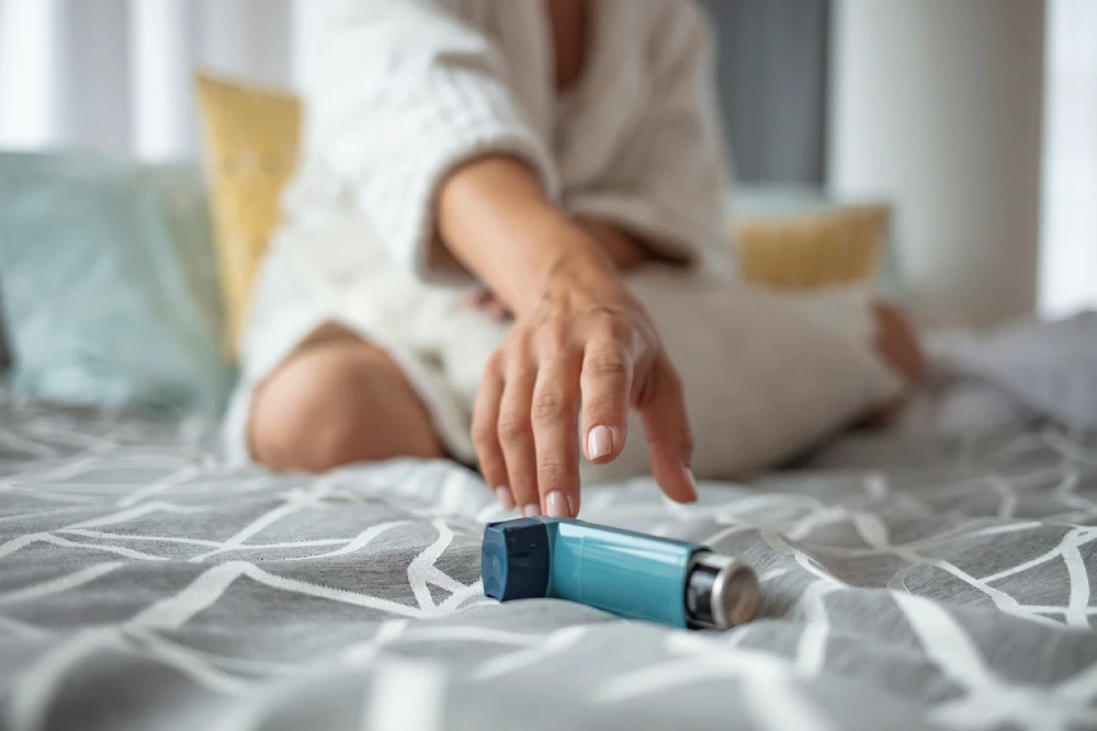 woman reaching for her inhaler for asthma management