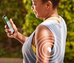 Woman checking Free Style Libre data on phone