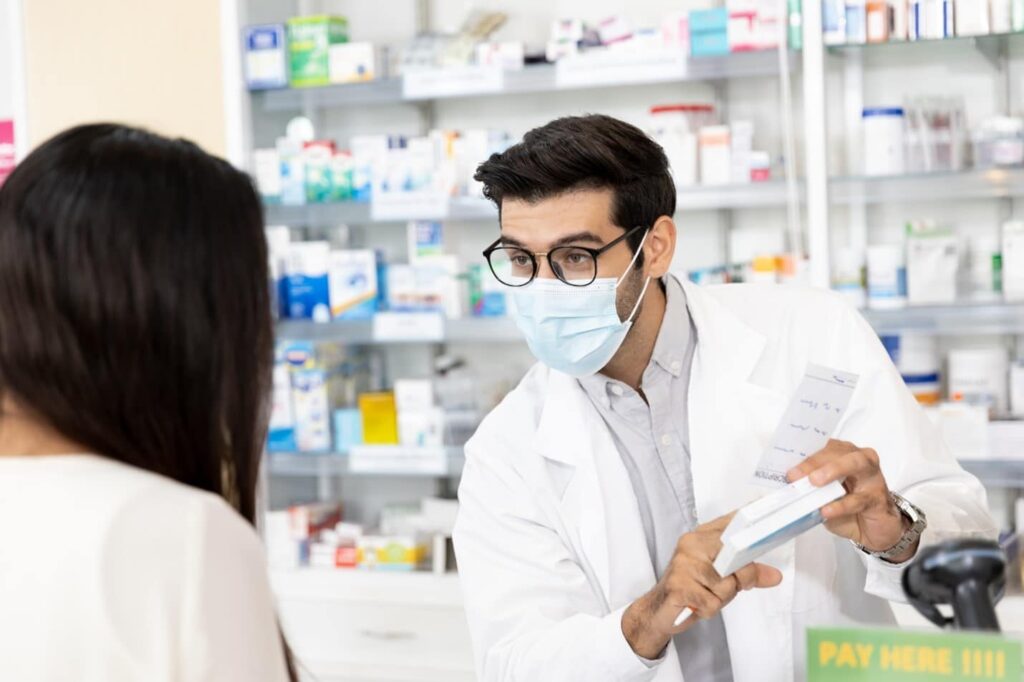 Pharmacist explaining a medication to a customer