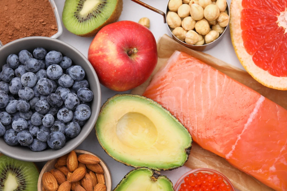 a spread of healthy food like fruit, avocado and fish