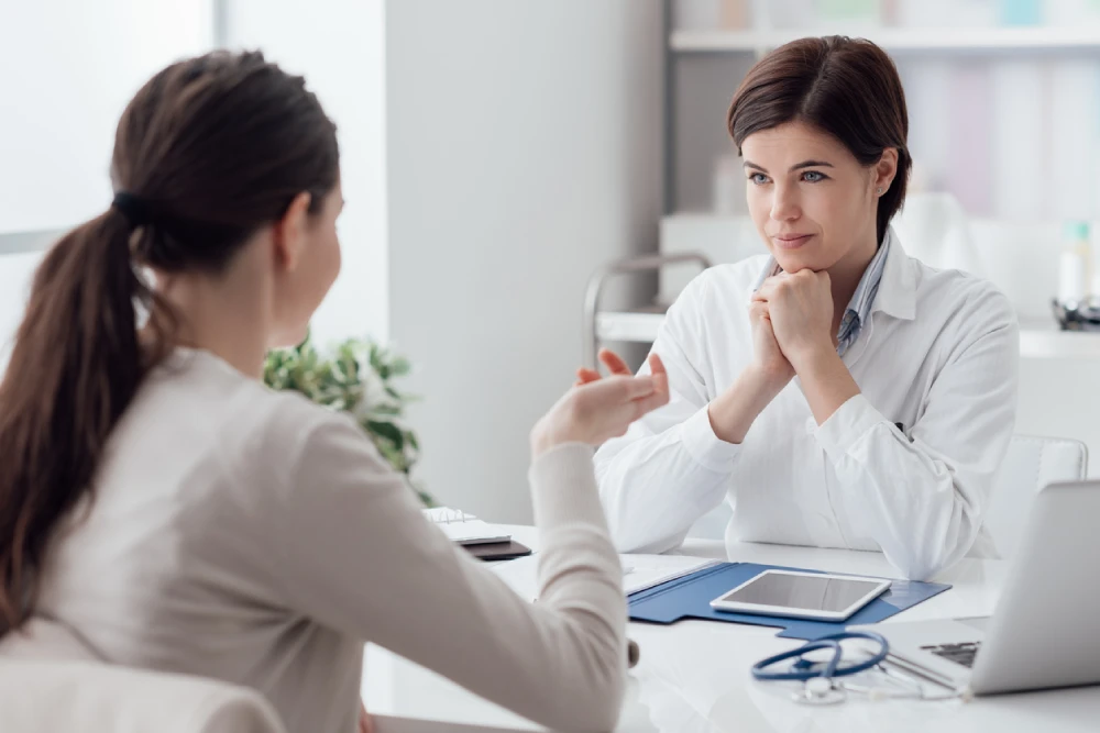 pharmacist and patient in a consultation to explore pharmacy wellness services