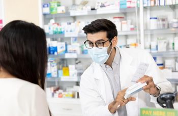 Pharmacist explaining a medication to a customer.