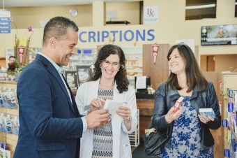 pharmacist assisting customers